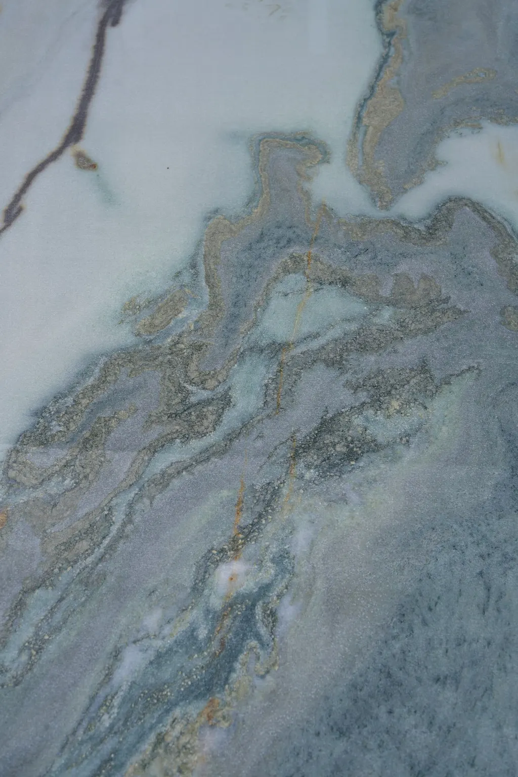 Front de taille strié, bleu et gris, de la carrière de Brando